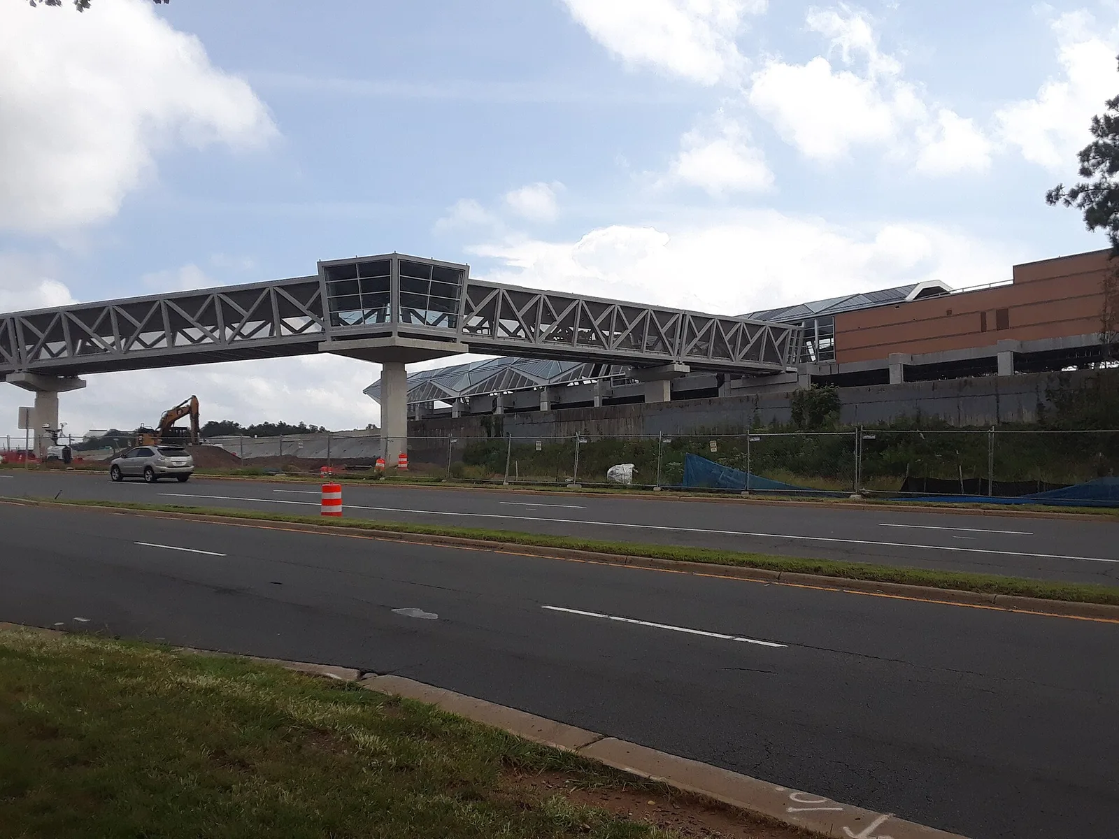 Reston Town Center station and its pedestrian bridge while under construction, seen from the road beside the station