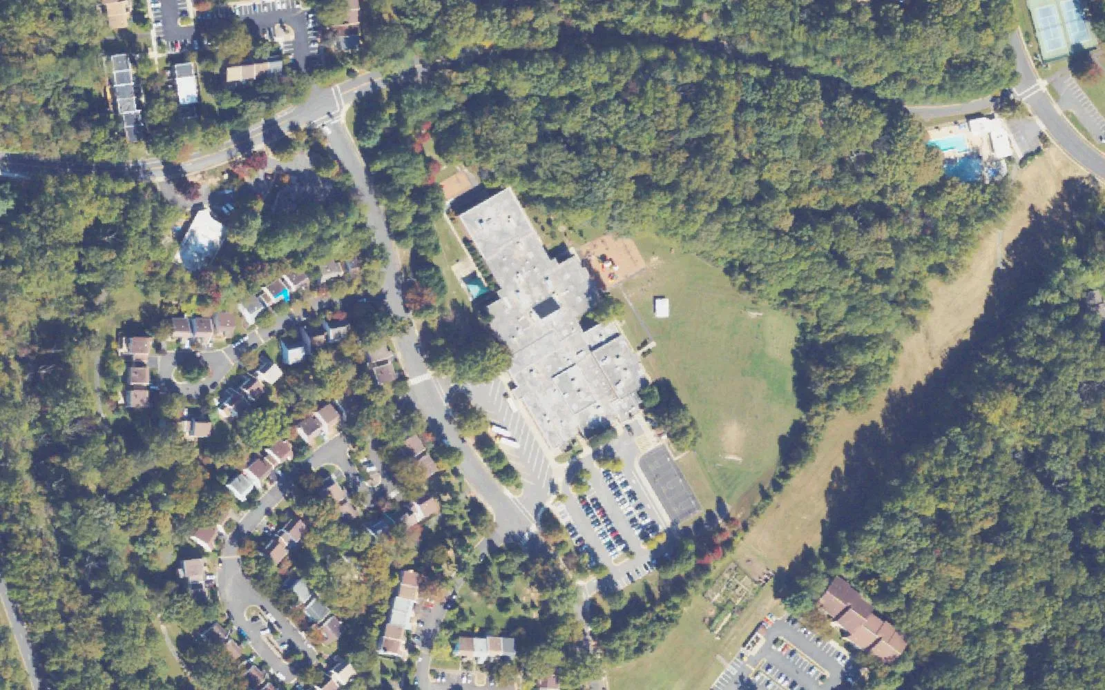 Forest Edge Elementary School off Becontree Lane in Reston, with its playing field and the power line corridor beside it, seen from the air